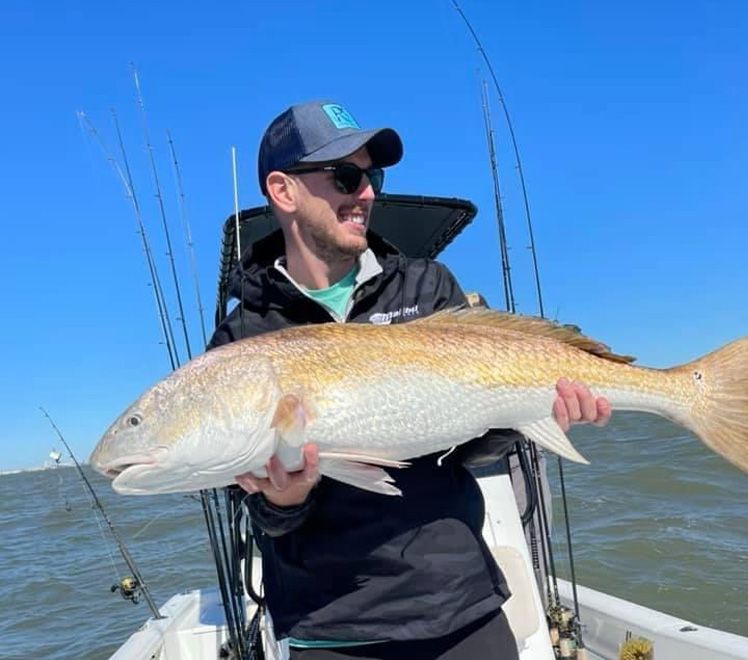 Owner Connor Steen holding a fresh caught fish